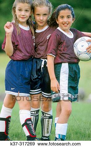 Stock Photo - 8 years old girls wearing school soccer team uniforms after playing a game. Fotosearch