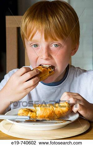 8 yr old boy eating croissants View Large Photo Image Stock Image - 8 yr old boy eating croissants. Fotosearch