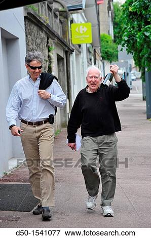 80 year old man with 50 year old son on their way to a celebration, Limoges, France View Large Photo Image Stock Photo - 80 year old man with 50 year old son on their way to a celebration, Limoges, France. Fotosearch