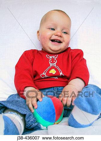 9 month old baby boy playing with ball (twin brother of twin picture no. J38-436006) View Large Photo Image Stock Photo - 9 month old baby boy playing with ball (twin brother of twin picture no. J38-436006). Fotosearch