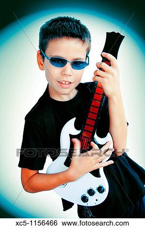 9 years old boy playing guitar View Large Photo Image Stock Photograph - 9 years old boy playing guitar. Fotosearch