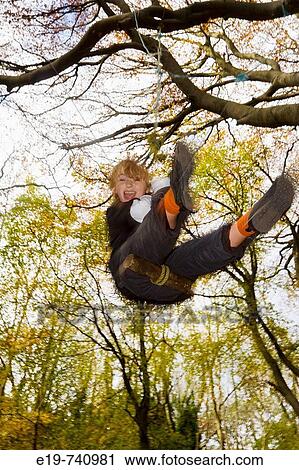 9 yr old boy on swing in autumnul wood, Gloucestershire, UK View Large Photo Image Stock Image - 9 yr old boy on swing in autumnul wood, Gloucestershire, UK. Fotosearch