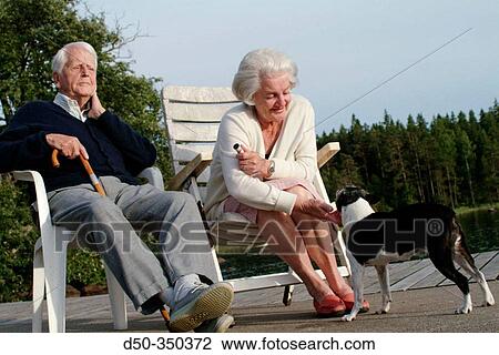 94 year old man with wife and dog enjoying sunset on dock. Medevi, Sweden View Large Photo Image Stock Image - 94 year old man with wife and dog enjoying sunset on dock. Medevi, Sweden. Fotosearch