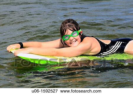 a 10 year old girl on a surfboard View Large Photo Image Stock Photo - a 10 year old girl on a surfboard. Fotosearch