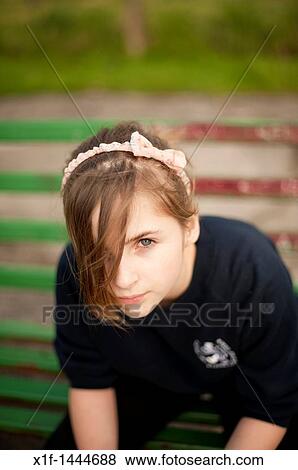 Stock Photo - A 12-13 year teenage old girl, outdoors UK. Fotosearch