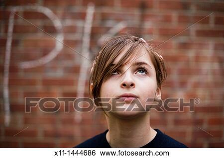 A 12-13 year teenage old girl, outdoors UK, looking up View Large Photo Image Stock Photograph - A 12-13 year teenage old girl, outdoors UK, looking up. Fotosearch