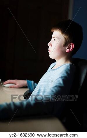 A 12 year old boy on his computer on Facebook internet website using very shallow depth of field View Large Photo Image Stock Image - A 12 year old boy on his computer on Facebook internet website using very shallow depth of field. Fotosearch