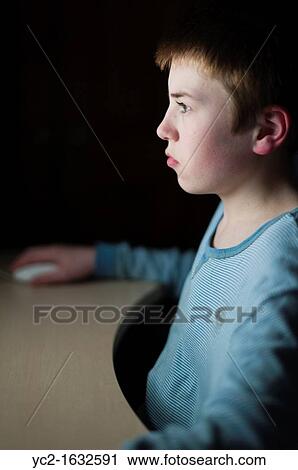 A 12 year old boy on his computer on Facebook internet website using very shallow depth of field View Large Photo Image Stock Image - A 12 year old boy on his computer on Facebook internet website using very shallow depth of field. Fotosearch