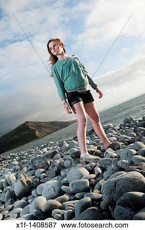 A 12 year old girl standy on a rocky beach, wales UK View Large Photo Image Stock Photo - A 12 year old girl standy on a rocky beach, wales UK. Fotosearch