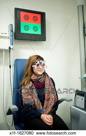 A 13 year old teenage girl having her eyes tested at an opticians, UK View Large Photo Image Stock Image - A 13 year old teenage girl having her eyes tested at an opticians, UK. Fotosearch
