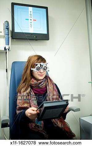 A 13 year old teenage girl having her eyes tested at an opticians, UK View Large Photo Image Stock Photo - A 13 year old teenage girl having her eyes tested at an opticians, UK. Fotosearch