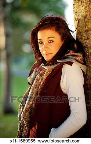 Stock Photography - A 14 15 year old caucasian teenage girl, UK, outdoors, autumn, woodland. Fotosearch