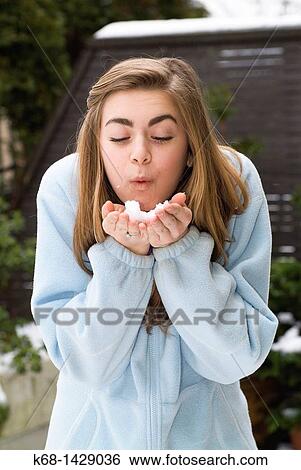 a 15 year old girl outdoors, blowing snow from her hands View Large Photo Image Stock Photograph - a 15 year old girl outdoors, blowing snow from her hands. Fotosearch