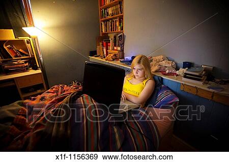a 15 year old teenage girl using her laptop to chat with her friends online from her bedroom, UK View Large Photo Image Stock Photo - a 15 year old teenage girl using her laptop to chat with her friends online from her bedroom, UK. Fotosearch