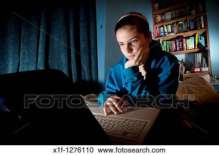 A 16 sixteen year old teenage girl reading Facebook on her laptop in her bedroom at home UK View Large Photo Image Stock Image - A 16 sixteen year old teenage girl reading Facebook on her laptop in her bedroom at home UK. Fotosearch