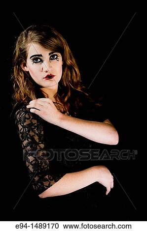 A 19 year old brunette woman with dramaitc make up looking directly at the camera. View Large Photo Image Stock Image - A 19 year old brunette woman with dramaitc make up looking directly at the camera.. Fotosearch
