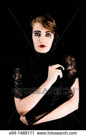 A 19 year old brunette woman with dramaitc make up looking directly at the camera. View Large Photo Image Stock Image - A 19 year old brunette woman with dramaitc make up looking directly at the camera.. Fotosearch