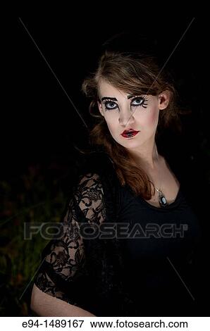 A 19 year old brunette woman with dramaitc make up looking directly at the camera. View Large Photo Image Stock Photo - A 19 year old brunette woman with dramaitc make up looking directly at the camera.. Fotosearch