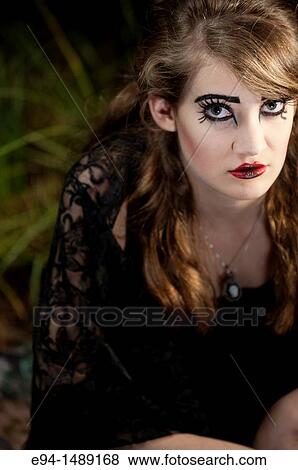 A 19 year old brunette woman with dramaitc make up looking directly at the camera. View Large Photo Image Stock Photo - A 19 year old brunette woman with dramaitc make up looking directly at the camera.. Fotosearch