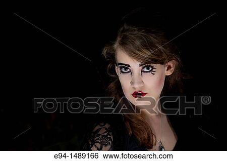 A 19 year old brunette woman with dramaitc make up looking directly at the camera. View Large Photo Image Stock Photograph - A 19 year old brunette woman with dramaitc make up looking directly at the camera.. Fotosearch