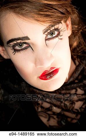 A 19 year old brunette woman with dramaitc make up looking directly at the camera. View Large Photo Image Stock Photography - A 19 year old brunette woman with dramaitc make up looking directly at the camera.. Fotosearch