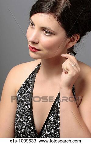 A 20-something attactive female in a sleeveless dress with a red ribbon in her hair and expressive hand gestures View Large Photo Image Stock Image - A 20-something attactive female in a sleeveless dress with a red ribbon in her hair and expressive hand gestures. Fotosearch