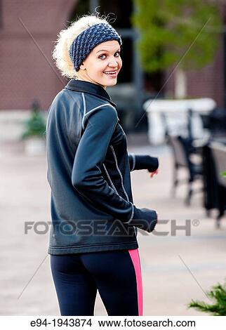 A 22 year old blond woman jogging in an urban environment. View Large Photo Image Picture - A 22 year old blond woman jogging in an urban environment.. Fotosearch