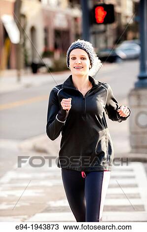 A 22 year old blond woman jogging in an urban environment. View Large Photo Image Stock Image - A 22 year old blond woman jogging in an urban environment.. Fotosearch