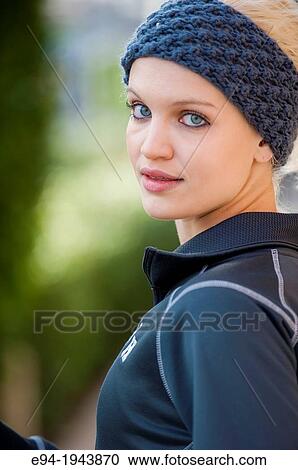 A 22 year old blond woman wearing jogging clothes smiling at the camera. View Large Photo Image Stock Image - A 22 year old blond woman wearing jogging clothes smiling at the camera.. Fotosearch