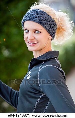 A 22 year old blond woman wearing jogging clothes smiling at the camera. View Large Photo Image Stock Image - A 22 year old blond woman wearing jogging clothes smiling at the camera.. Fotosearch
