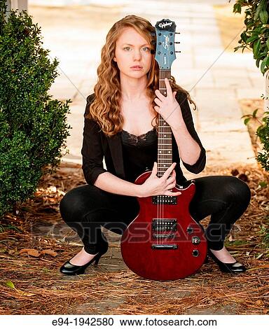 A 22 year old blond woman with a guitar in a garden setting. View Large Photo Image Stock Image - A 22 year old blond woman with a guitar in a garden setting.. Fotosearch