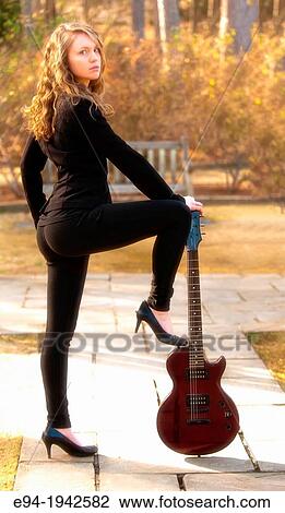 A 22 year old blond woman with a guitar in a garden setting. View Large Photo Image Stock Image - A 22 year old blond woman with a guitar in a garden setting.. Fotosearch