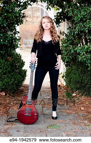 A 22 year old blond woman with a guitar in a garden setting. View Large Photo Image Stock Photo - A 22 year old blond woman with a guitar in a garden setting.. Fotosearch