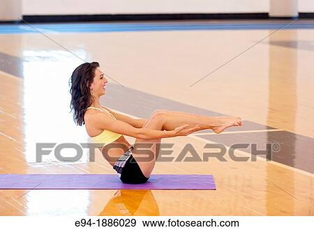 A 22 year old brunette woman doing a yoga pose indoors View Large Photo Image Stock Photo - A 22 year old brunette woman doing a yoga pose indoors. Fotosearch