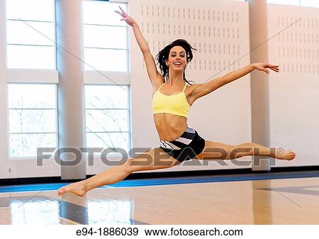 A 22 year old brunette woman doing dance leaps indoors View Large Photo Image Stock Photo - A 22 year old brunette woman doing dance leaps indoors. Fotosearch