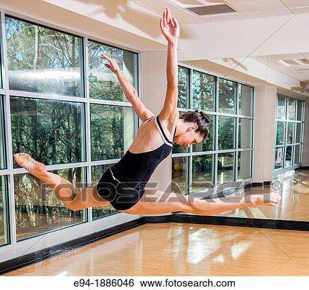 A 22 year old brunette woman doing dance leap indoors View Large Photo Image Stock Photograph - A 22 year old brunette woman doing dance leap indoors. Fotosearch