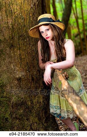 A 22 year old brunette woman in a bamboo forest wearing a summer dress and a straw hat looking directly at the camera. View Large Photo Image Stock Image - A 22 year old brunette woman in a bamboo forest wearing a summer dress and a straw hat looking directly at the camera.. Fotosearch