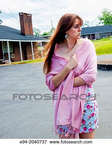 A 22 year old brunette woman looking away from the camera standing in a parking lot wearing a short dress holding a pink shawl around her shoulders. View Large Photo Image Stock Photo - A 22 year old brunette woman looking away from the camera standing in a parking lot wearing a short dress holding a pink shawl around her shoulders.. Fotosearch