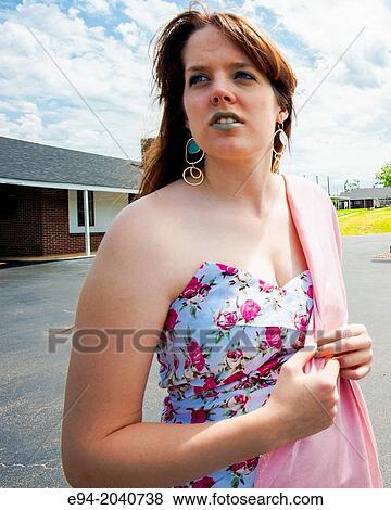 A 22 year old brunette woman looking away from the camera standing in a parking lot wearing a sleeveless dress with a pink shawl hanging off of one shoulder. View Large Photo Image Stock Photo - A 22 year old brunette woman looking away from the camera standing in a parking lot wearing a sleeveless dress with a pink shawl hanging off of one shoulder.. Fotosearch