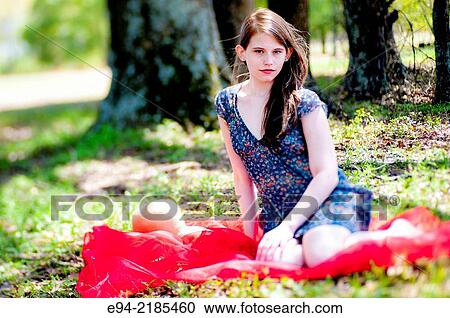 A 22 year old brunette woman wearing a summer dress sitting on a blanket in a pasture. View Large Photo Image Stock Image - A 22 year old brunette woman wearing a summer dress sitting on a blanket in a pasture.. Fotosearch