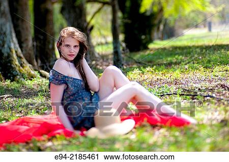 A 22 year old brunette woman wearing a summer dress sitting on a blanket in a pasture. View Large Photo Image Stock Image - A 22 year old brunette woman wearing a summer dress sitting on a blanket in a pasture.. Fotosearch