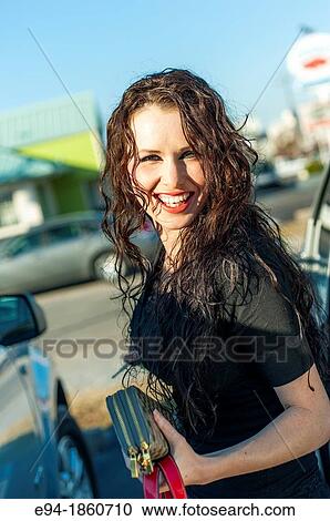A 24 year old brunette woman getting out of a car in a parking lot View Large Photo Image Stock Image - A 24 year old brunette woman getting out of a car in a parking lot. Fotosearch