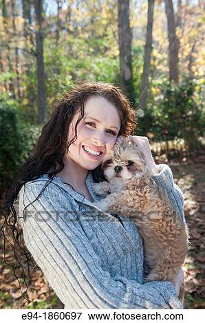 A 24 year old brunette woman holding and paling with Shih Tzu dog outdoors in the fall View Large Photo Image Stock Photo - A 24 year old brunette woman holding and paling with Shih Tzu dog outdoors in the fall. Fotosearch