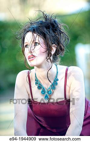 A 24 year old brunette woman in a fancy red dress on a sunny day outdoors. View Large Photo Image Stock Photo - A 24 year old brunette woman in a fancy red dress on a sunny day outdoors.. Fotosearch