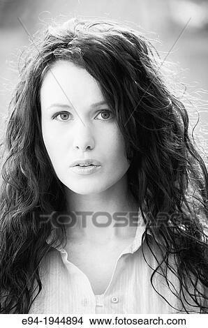 A 24 year old brunette woman in casual clothing outdoors, black & white. View Large Photo Image Picture - A 24 year old brunette woman in casual clothing outdoors, black & white.. Fotosearch