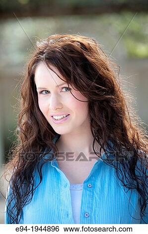 A 24 year old brunette woman in casual clothing outdoors wearing a blue top. View Large Photo Image Stock Photograph - A 24 year old brunette woman in casual clothing outdoors wearing a blue top.. Fotosearch