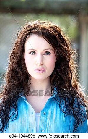 A 24 year old brunette woman in casual clothing outdoors wearing a blue top. View Large Photo Image Stock Photography - A 24 year old brunette woman in casual clothing outdoors wearing a blue top.. Fotosearch
