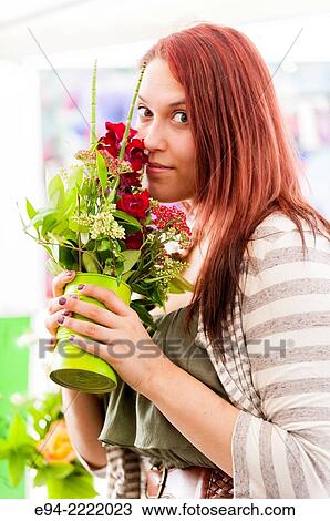 A 24 year old brunette woman smelling fresh flowers in an outdoor market. View Large Photo Image Stock Image - A 24 year old brunette woman smelling fresh flowers in an outdoor market.. Fotosearch