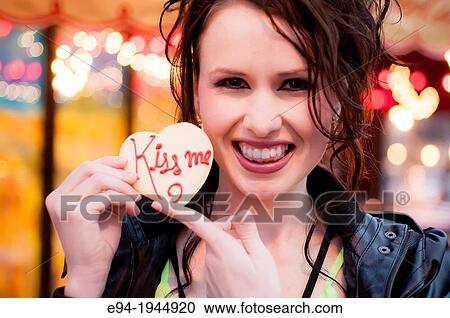 A 24 year old brunette woman smiling at the camera holding a cookie. View Large Photo Image Stock Image - A 24 year old brunette woman smiling at the camera holding a cookie.. Fotosearch