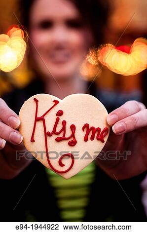 A 24 year old brunette woman smiling at the camera holding a cookie. View Large Photo Image Stock Image - A 24 year old brunette woman smiling at the camera holding a cookie.. Fotosearch